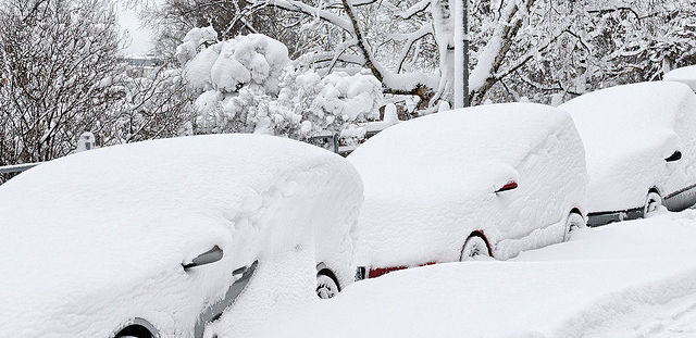 Vehicles covered in inches of snow
